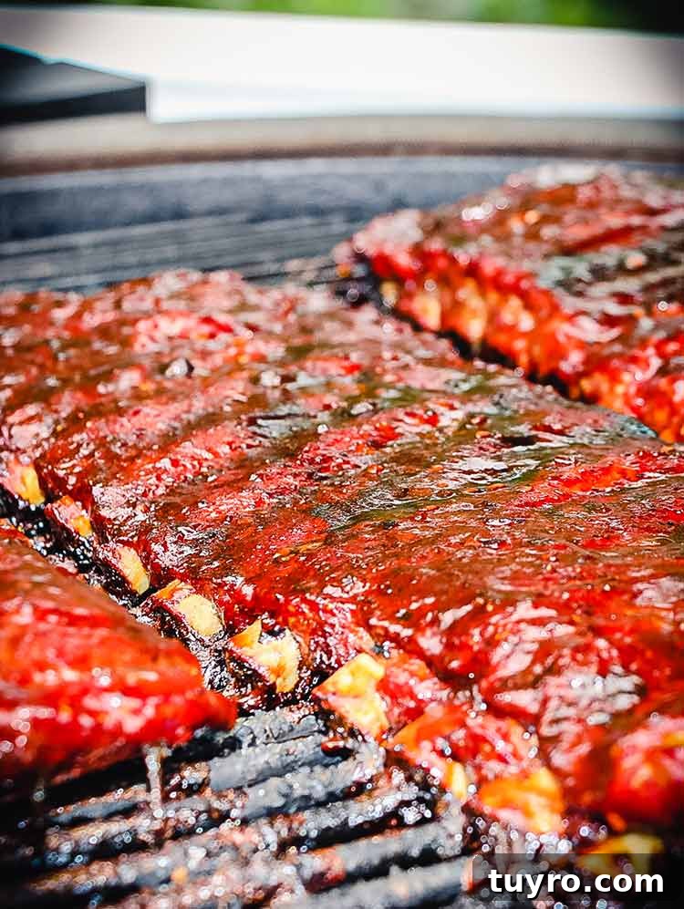 How to Tell When Pork Ribs Are Perfectly Cooked 3 ribs on grill with bones peeking out