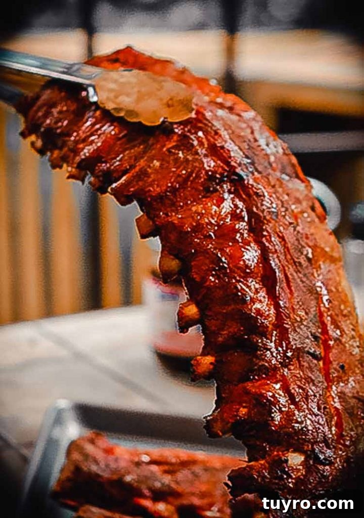 How to Tell When Pork Ribs Are Perfectly Cooked 4 bend the slab of ribs using a pair of tongs