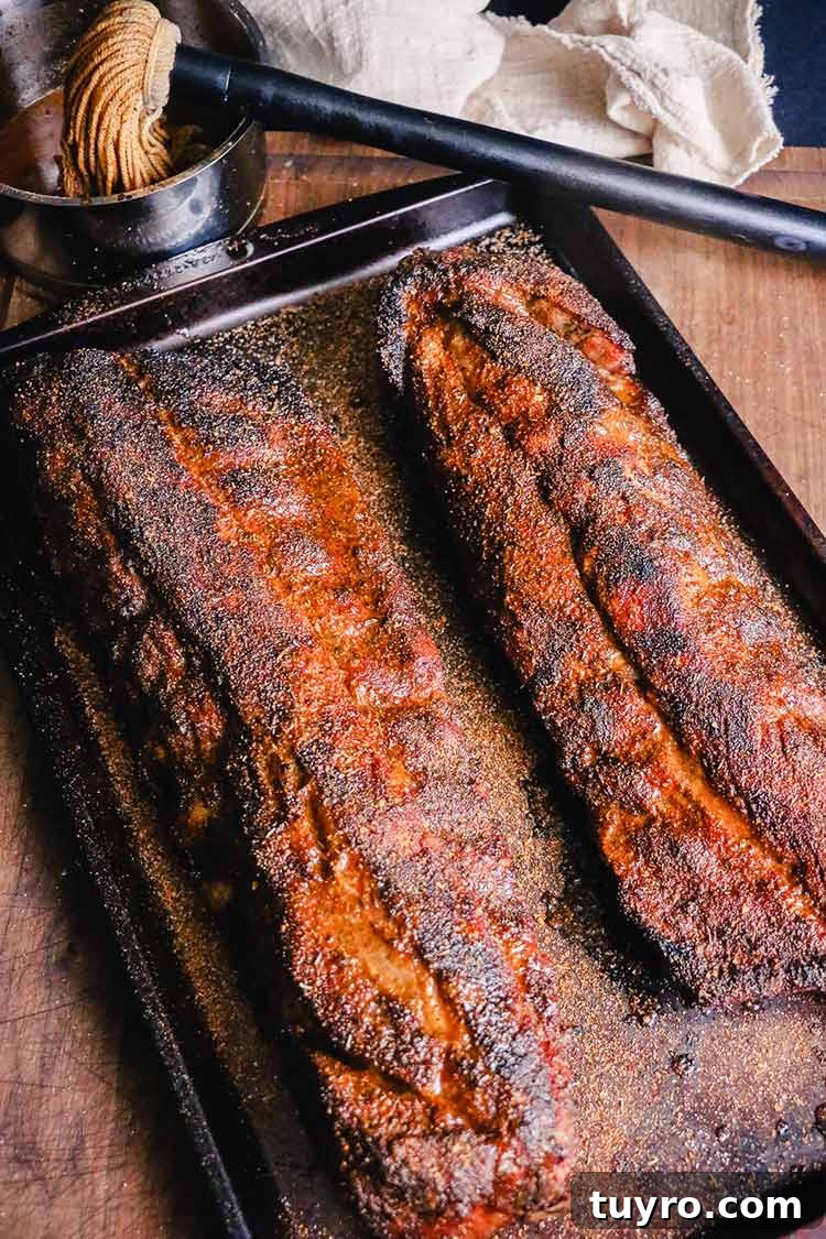 How to Tell When Pork Ribs Are Perfectly Cooked 9 pork ribs on a pan just out of the oven