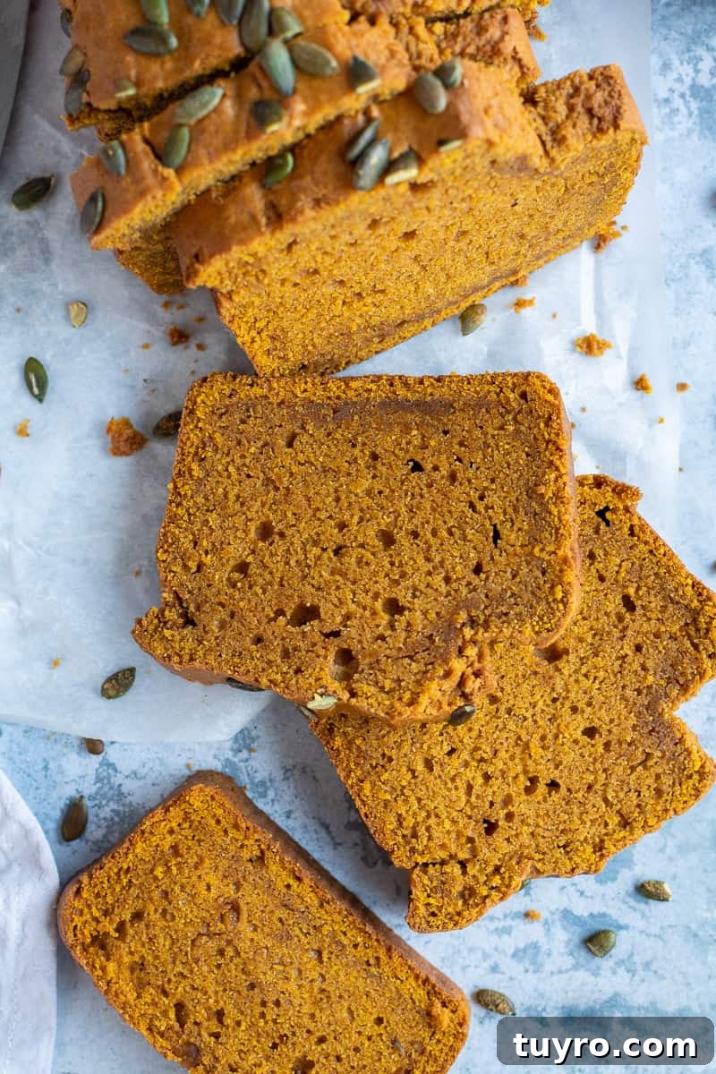 Vegan pumpkin bread - soft and moist loaf Close up of slices of vegan pumpkin cake from above on a blue background.