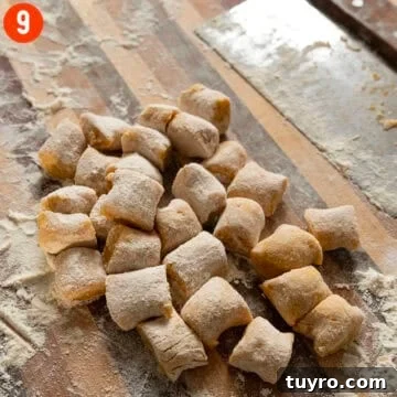 Homemade pumpkin gnocchi on a cutting board.
