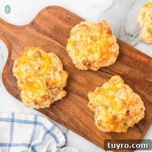 Copycat Cheddar Bay Biscuits Recipe 9 Biscuits on a wooden platter.