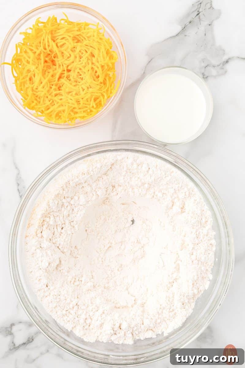 Copycat Cheddar Bay Biscuits Recipe 7 A bowl of flour, cheese, and milk.