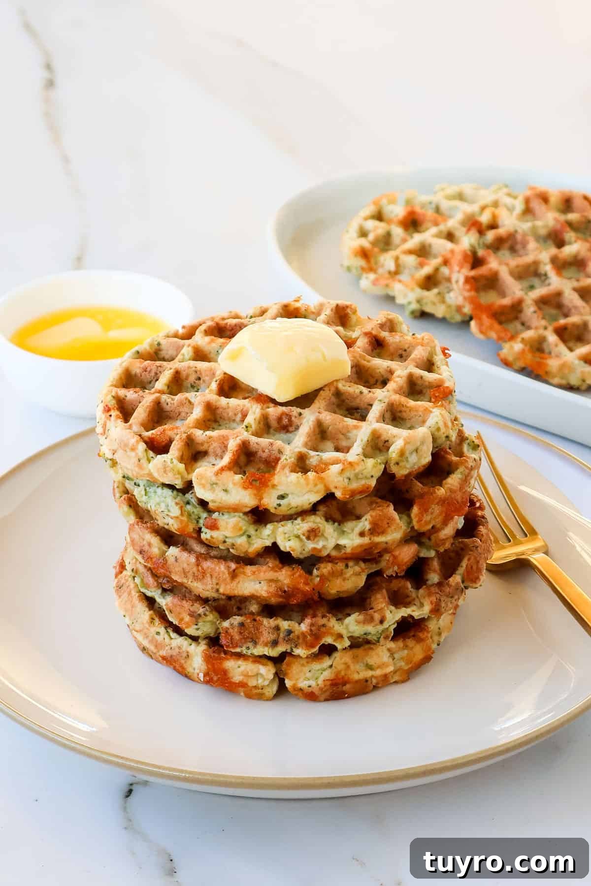 Broccoli Cheddar Waffles Recipe 2 Broccoli cheese waffles stacked on a plate.