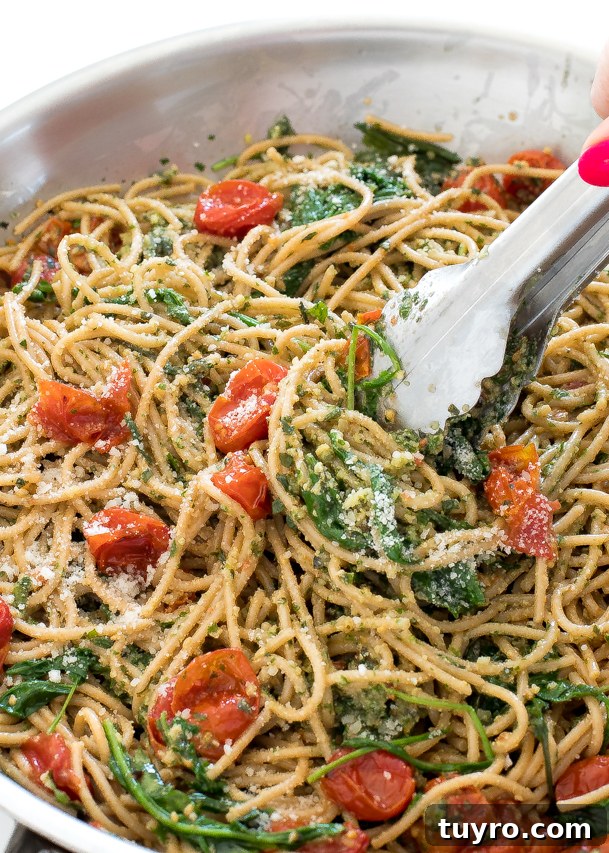 Creamy Walnut Pesto Pasta Recipe for Quick Weeknight Meals 4 Tongs holding pasta in a skillet.