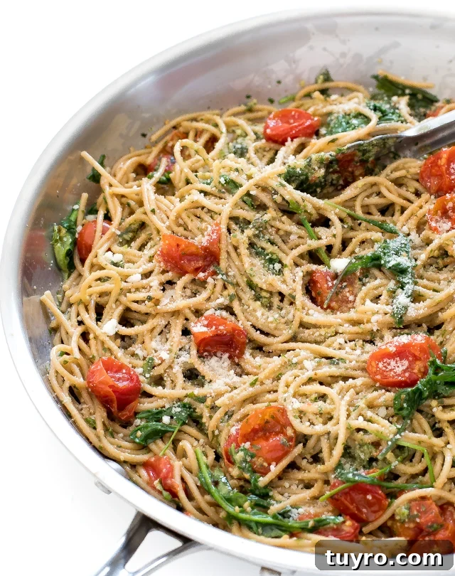 Creamy Walnut Pesto Pasta Recipe for Quick Weeknight Meals 9 Walnut Pesto Pasta in a skillet with tongs holding some of the pasta.