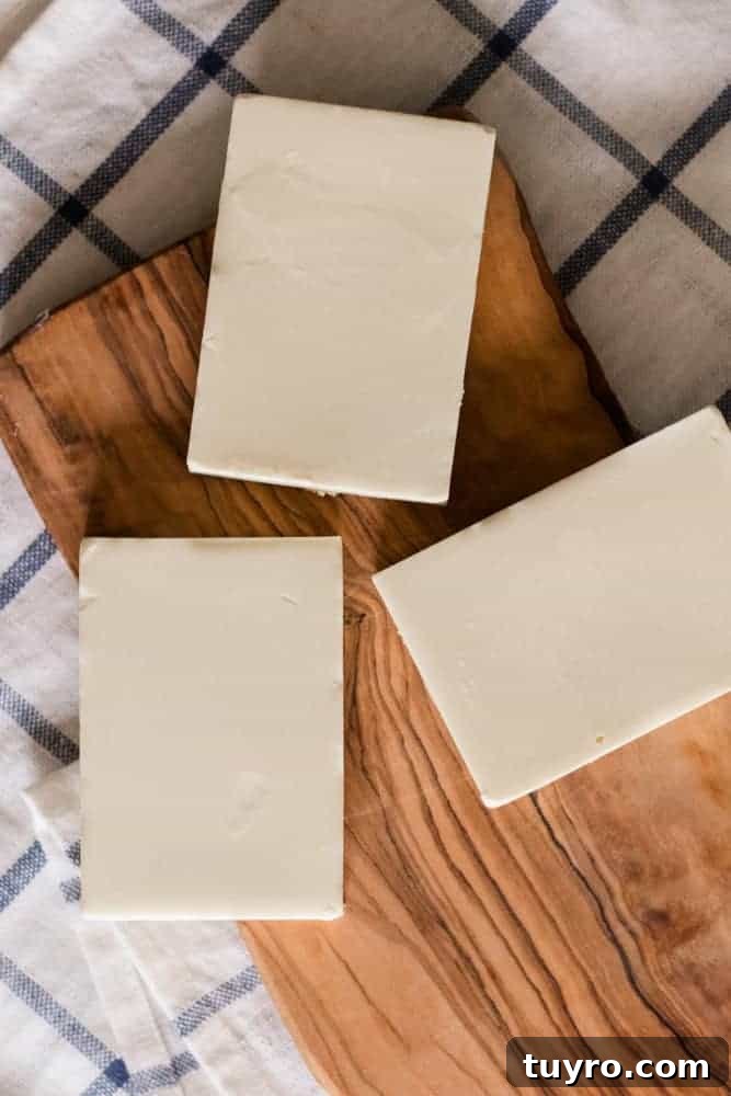 DIY Sunscreen Lotion Bar: Natural SPF Balm Recipe 2 Homemade sunscreen bars on wooden board.