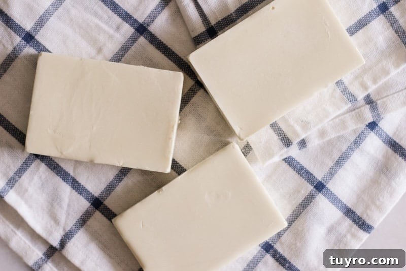 DIY Sunscreen Lotion Bar: Natural SPF Balm Recipe 5 White sunscreen bars on white and blue tea towel.