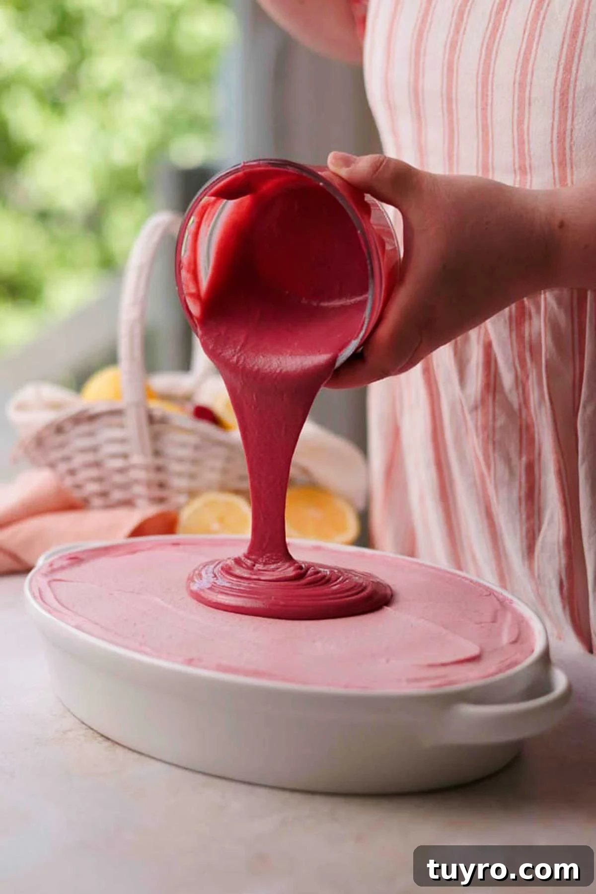 Raspberry Tiramisu Recipe: Light, Creamy Berry Dessert 14 pouring raspberry curd over tiramisu