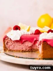lemon raspberry cheesecake with raspberry curd topping sliced