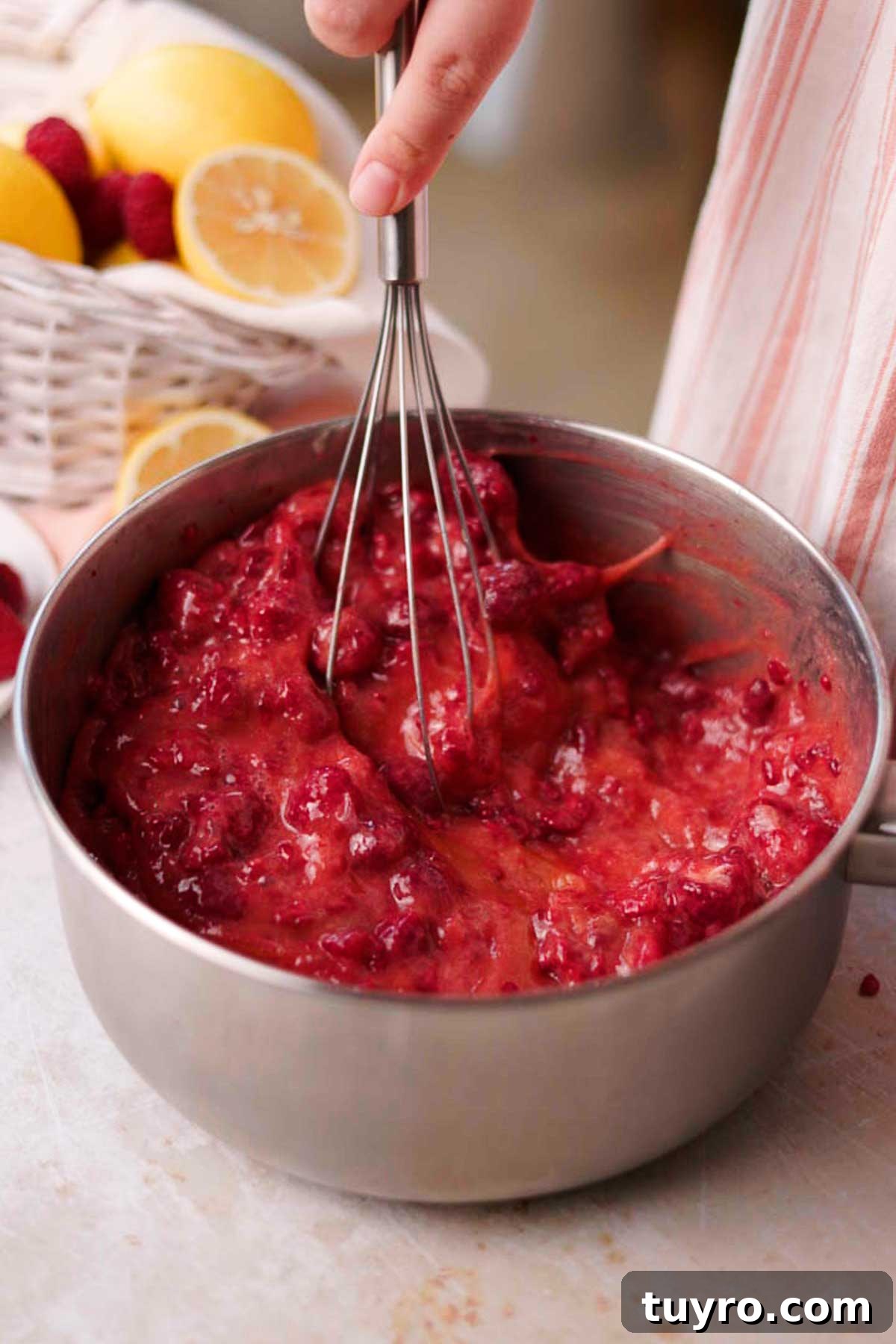 Raspberry Tiramisu Recipe: Light, Creamy Berry Dessert 5 stirring uncooked raspberry curd with a whisk