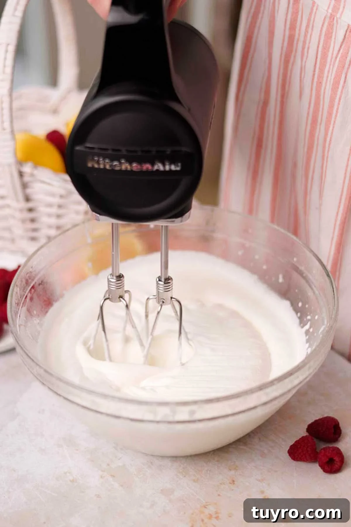 Raspberry Tiramisu Recipe: Light, Creamy Berry Dessert 9 whipping cream for raspberry tiramisu in glass bowl