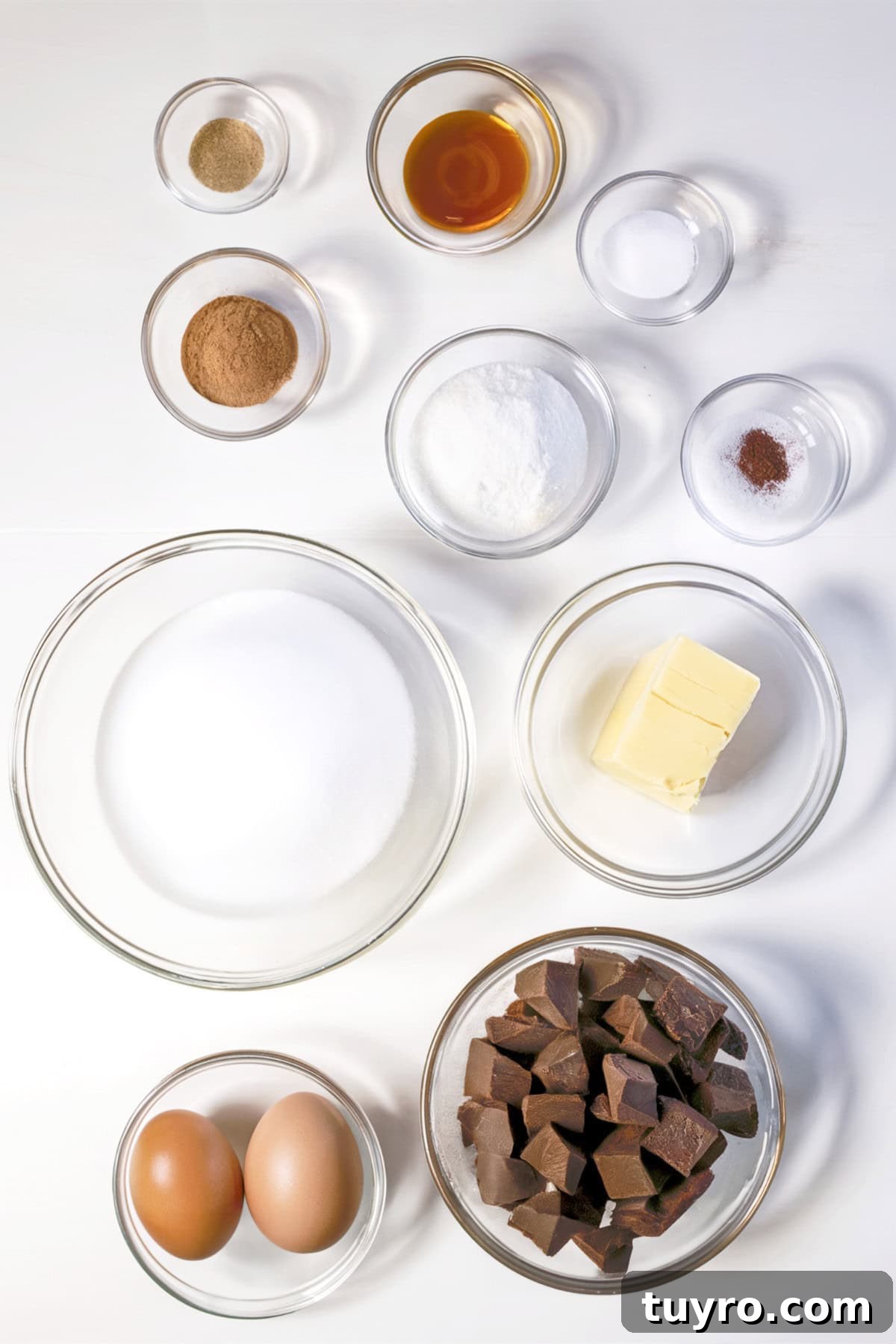 Flourless Mexican Chocolate Brownies with Cinnamon and Chili 3 Ingredients laid out on a white countertop in clear bowls.