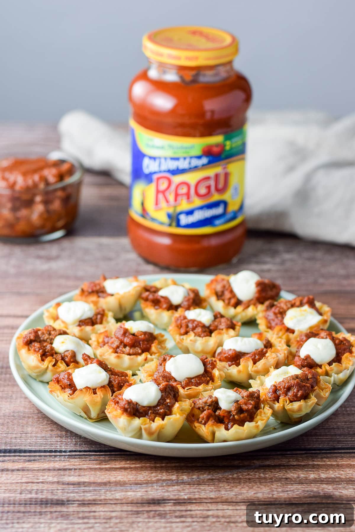Savory Sauced Beef Bites: Perfect Party Appetizer Recipe 2 A plate of the appetizer with a bottle of red sauce in the background