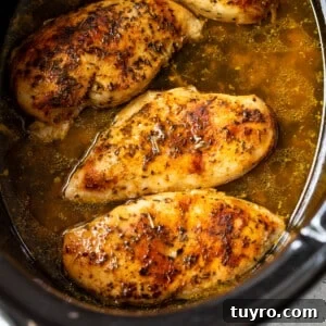 Tender Slow-Cooker Chicken Breast Recipe for Quick Meals 9 chicken breasts cooking in a slow cooker.