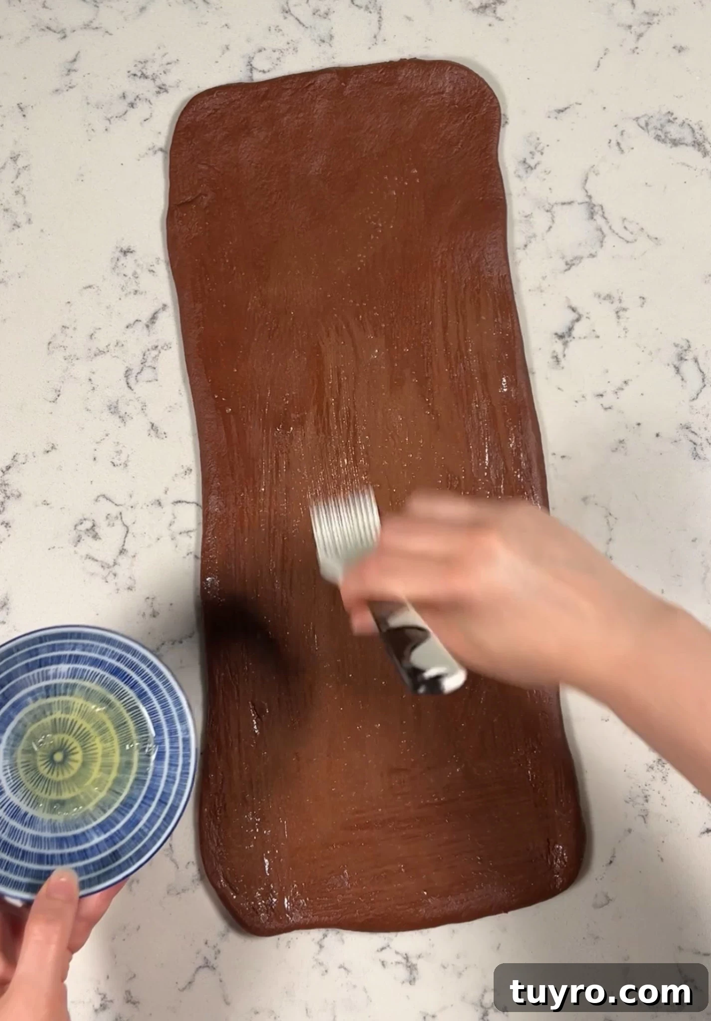 Chocolate Swirl Bread Recipe — Soft Homemade Choco Loaf 17 Adding egg wash to the dough.