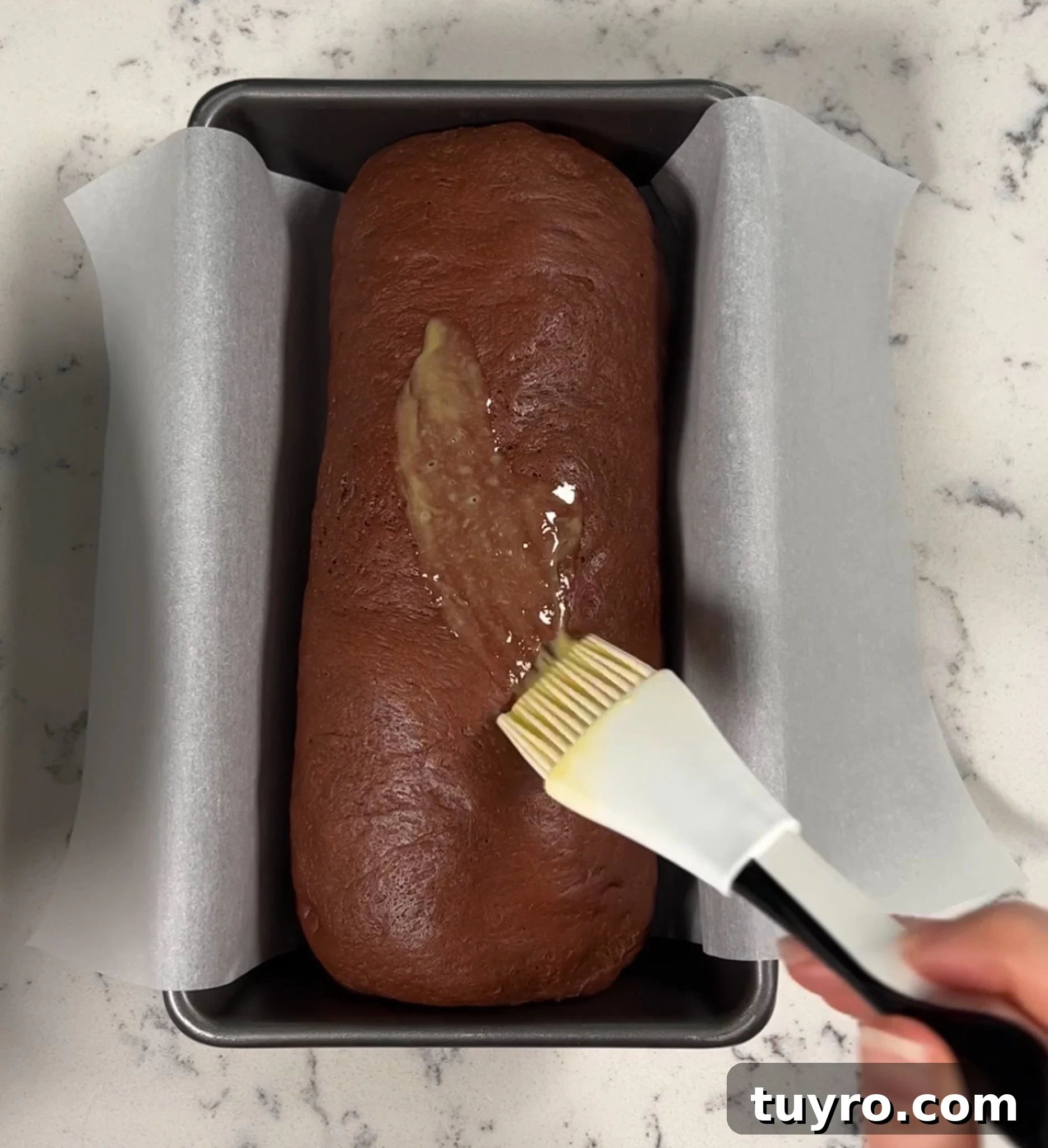 Chocolate Swirl Bread Recipe — Soft Homemade Choco Loaf 22 Brushing the loaf with egg wash.