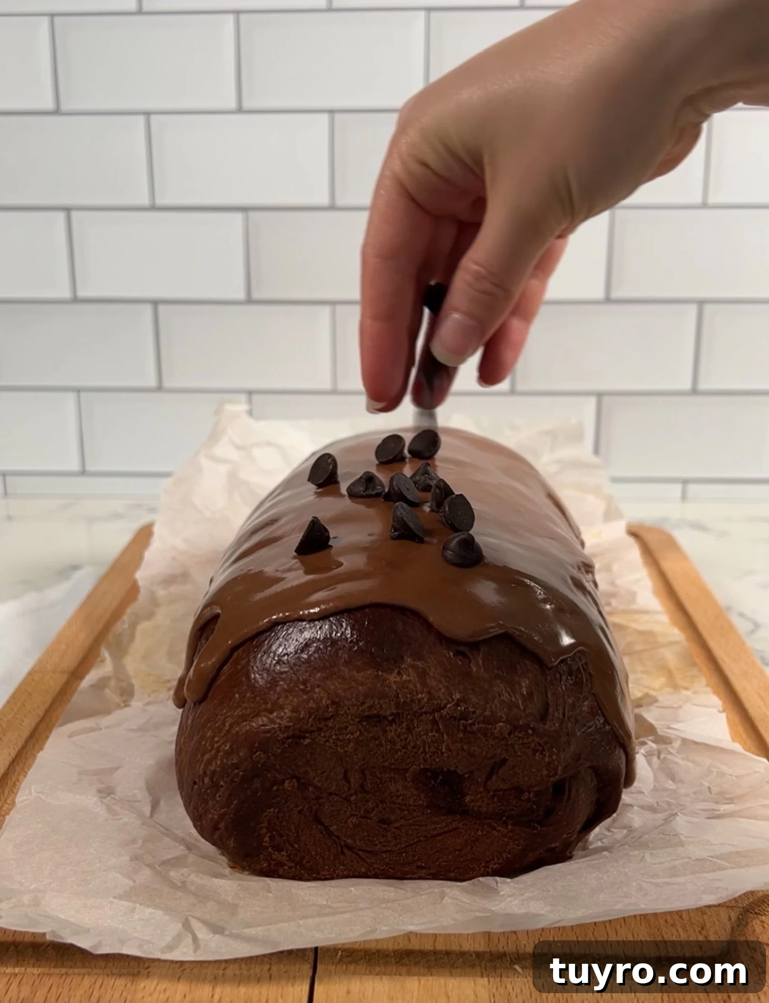 Chocolate Swirl Bread Recipe — Soft Homemade Choco Loaf 24 Adding chocolate chips to the top of the loaf.