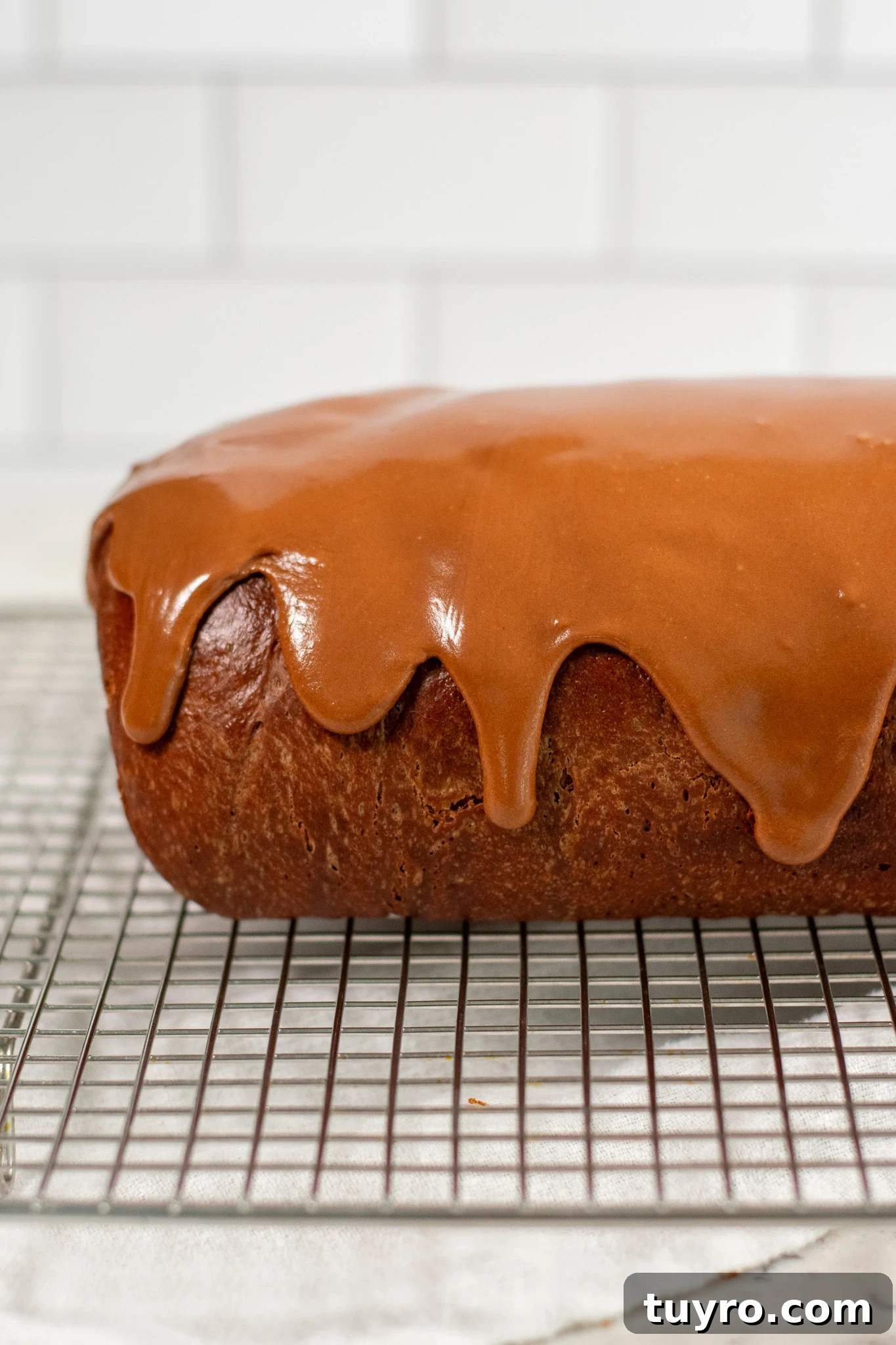 Chocolate Swirl Bread Recipe — Soft Homemade Choco Loaf 6 A chocolate swirl loaf with icing on top.