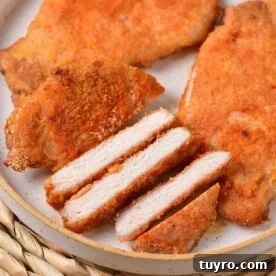 Slices of breaded thin pork chops are artfully arranged on a plate