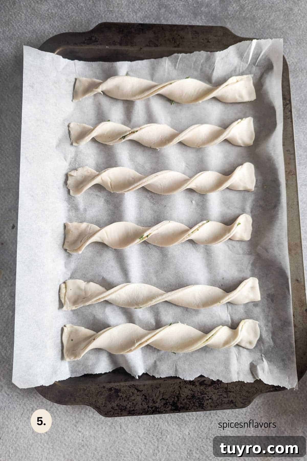 Cheesy Garlic Puff Pastry Twists Recipe for Savory Snacks 6 twisted puff pastry twists placed on baking sheet