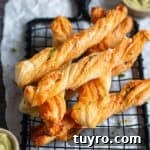 Cheesy Garlic Puff Pastry Twists Recipe for Savory Snacks 10 close up image of stacked garlic puff pastry twists