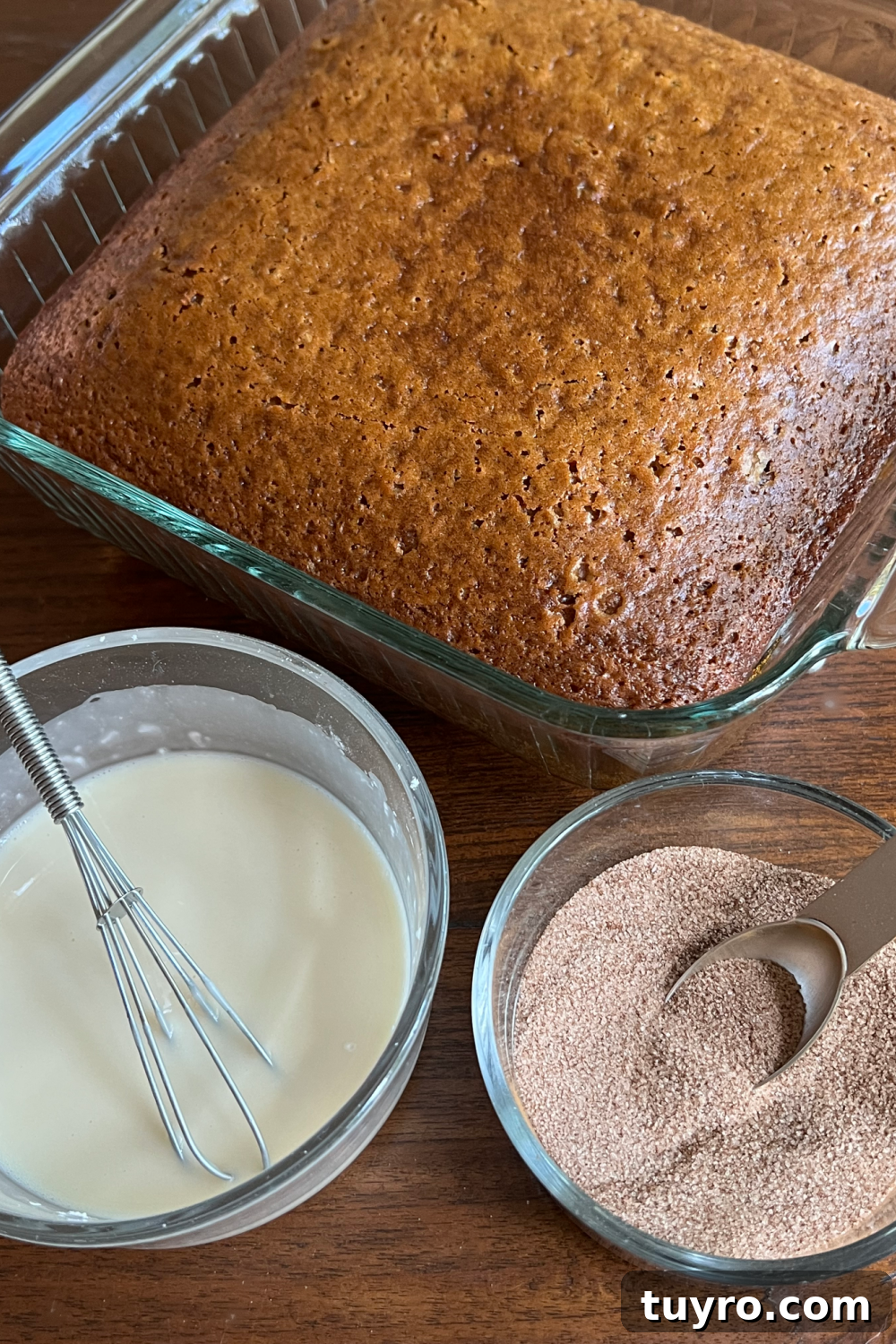 Apple Cider Crazy Cake — Vegan, Dairy-Free, No Eggs or Butter 6 This photo shows the cake after baking in the pan, with two small bowls with the glaze and the cinnamon sugar.