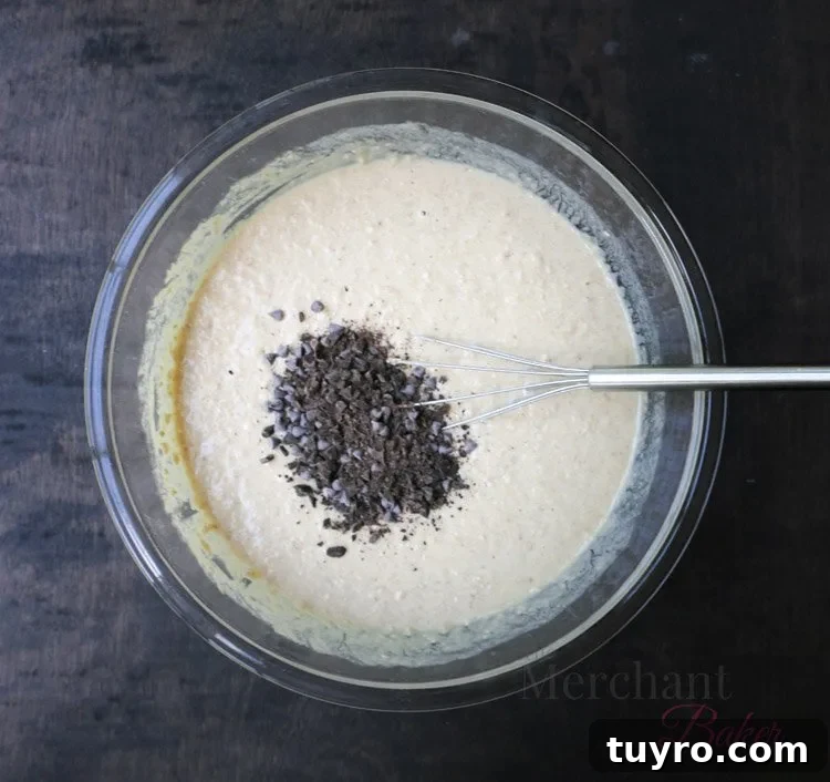 Chocolate chips being added to Oatmeal Chocolate Chip Banana Pancake Batter