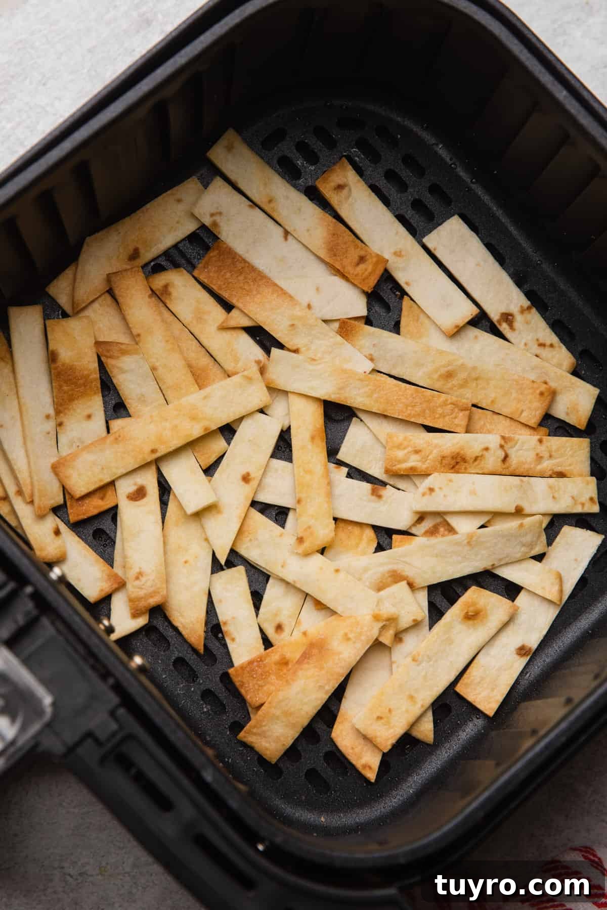 Crispy Air Fryer Tortilla Strips for Salads and Soups 7 Flour tortilla strips air fried to a golden brown.