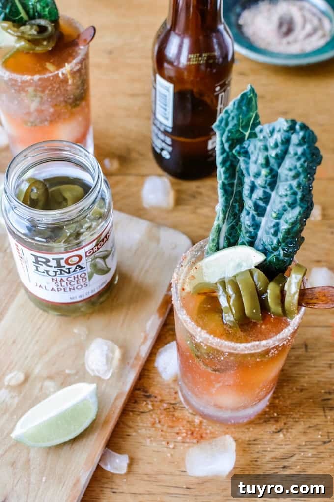 Spicy Jalapeno Michelada Recipe 3 #ad|This is the best Spicy Jalapeño Michelada you will ever try. This authentic Mexican beer cocktail is flavored with tomato juice, fiery pickling liquid from the peppers and a whole pile of jalapeños and lime. #michelada #jalapenos #beercocktail #beer #spicycocktail