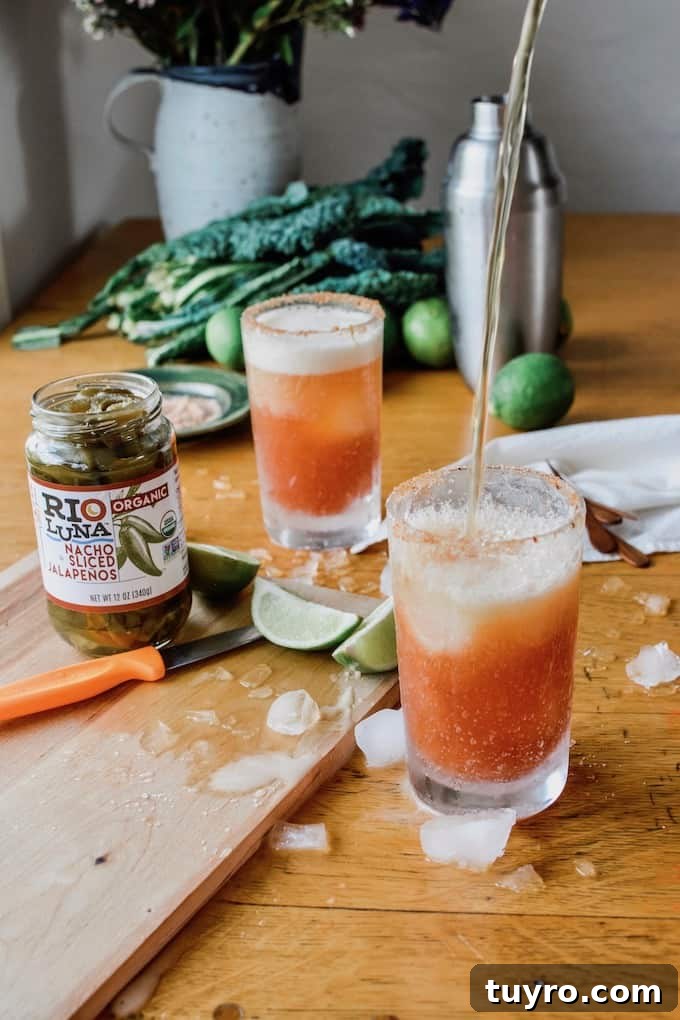 Spicy Jalapeno Michelada Recipe 4 #ad|This is the best authentic Mexican Spicy Jalapeño Michelada beer cocktail you will ever try, flavored with fiery pickling liquid from the peppers and a whole pile of jalapeños and lime. #michelada #jalapenos #beercocktail #beer #spicycocktail