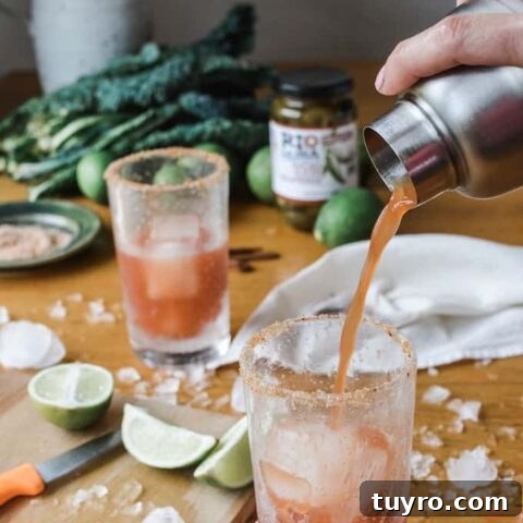 Spicy Jalapeño Michelada beer cocktail with pickled jalapeños, pickling liquid, lime, tomato juice, and cold lager.