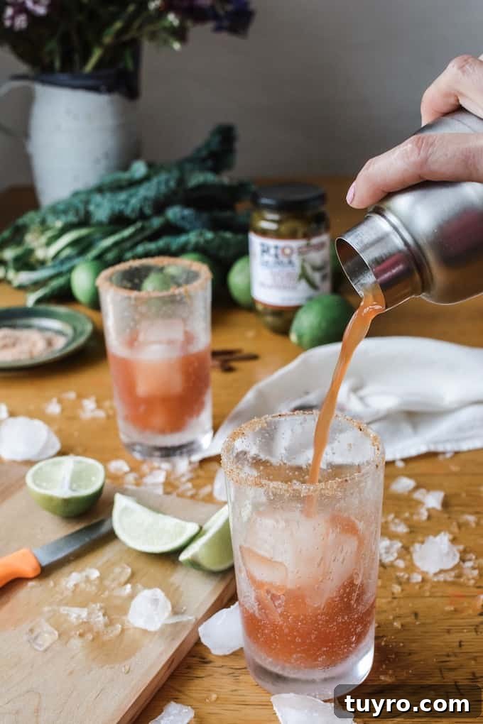 Spicy Jalapeño Michelada served with lime and pickled jalapeños.