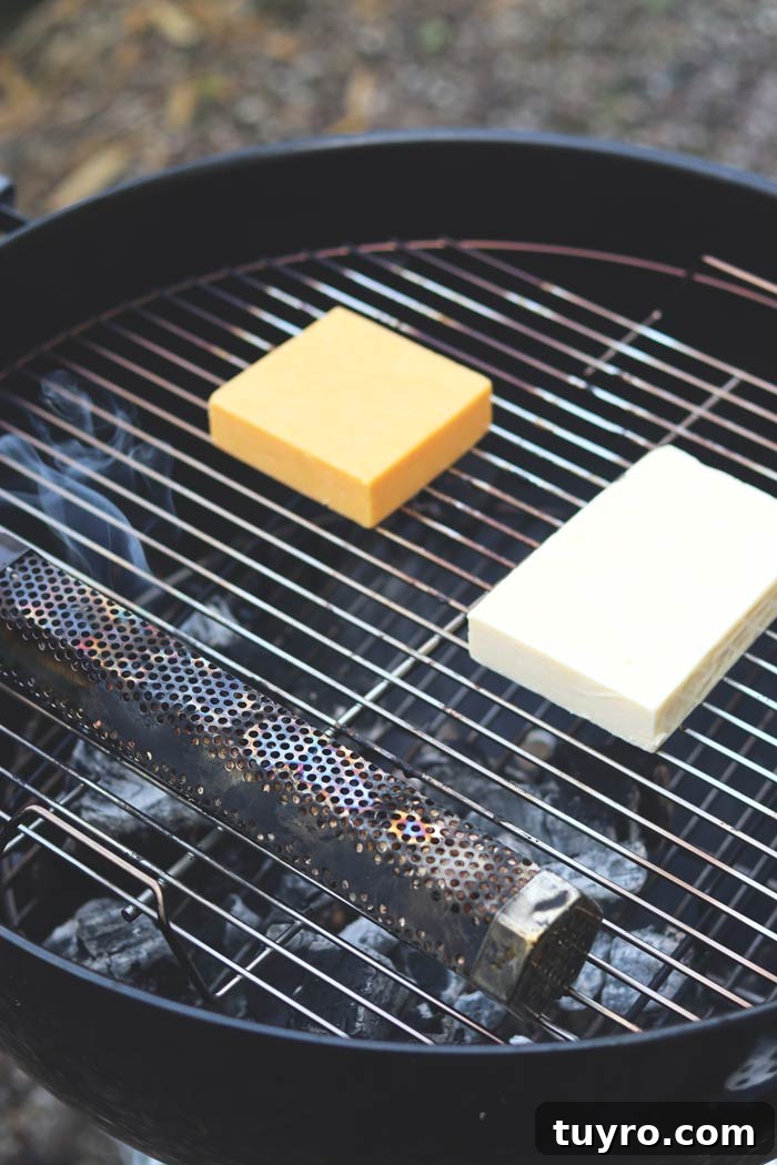 Cold Smoking Cheese: Complete Guide to Safe, Flavorful Results 3 cheddar and red leicester cheese on charcoal grill grates with pellet smoker tube