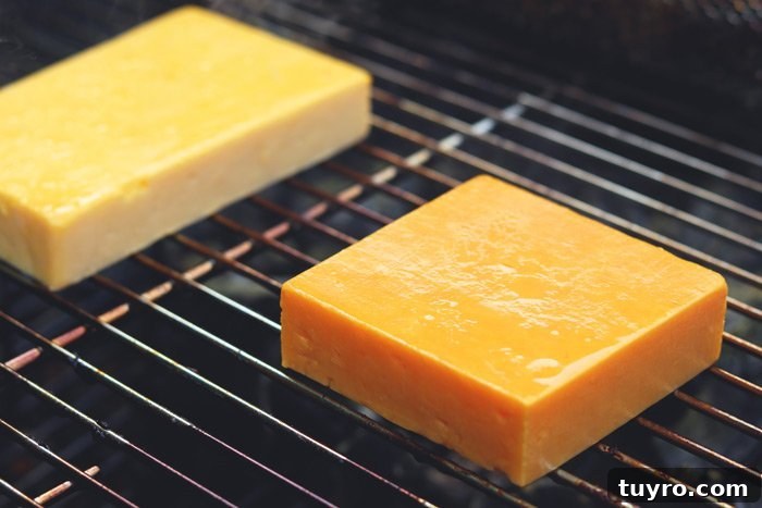 Cold Smoking Cheese: Complete Guide to Safe, Flavorful Results 4 red leicester and cheddar cheese during cold smoking process on charcoal grill grates