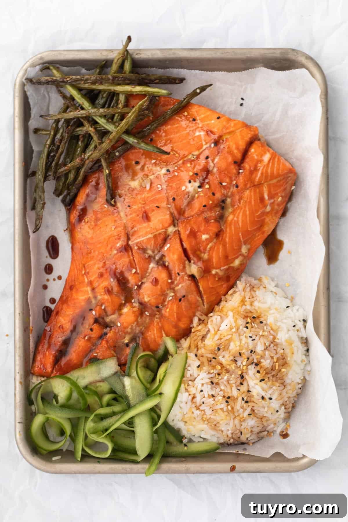 Baked Teriyaki Salmon in 15 Minutes — 2-Ingredient Recipe 2 Teriyaki Salmon on a sheet pan with rice and vegetables.