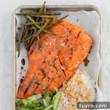 Baked Teriyaki Salmon in 15 Minutes — 2-Ingredient Recipe 12 Teriyaki Salmon on a sheet pan with rice and vegetables.