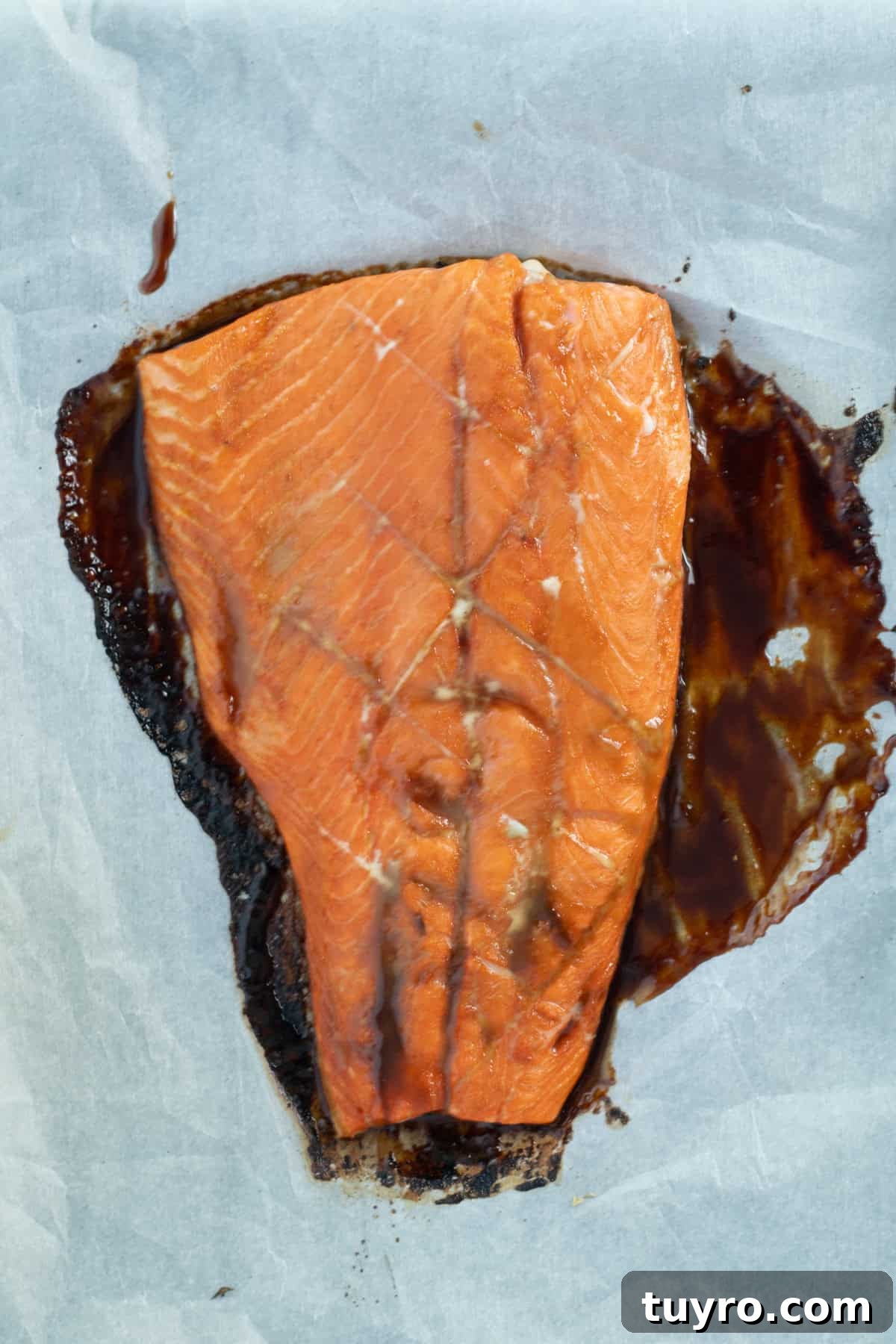 Baked Teriyaki Salmon in 15 Minutes — 2-Ingredient Recipe 5 baked teriyaki salmon on parchment paper.