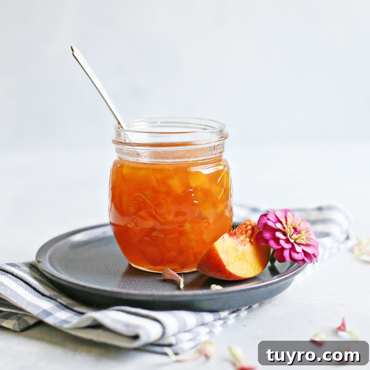 homemade peach syrup in a jar