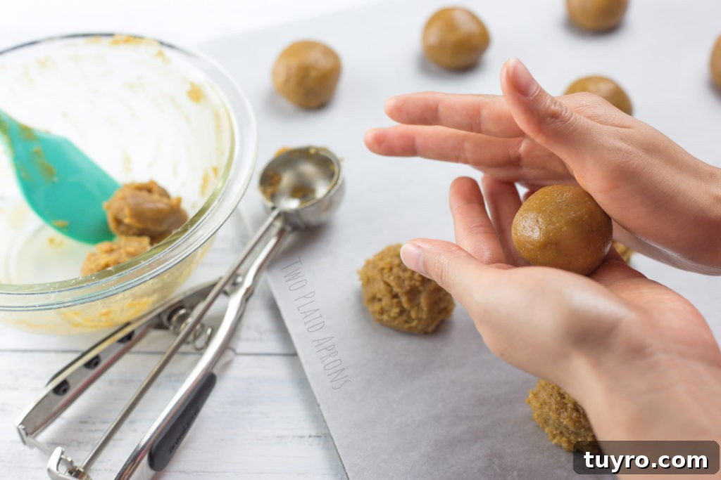 Chewy Gluten-Free Peanut Butter Cookies Recipe 3 Gluten free peanut butter cookie dough being rolled into balls.