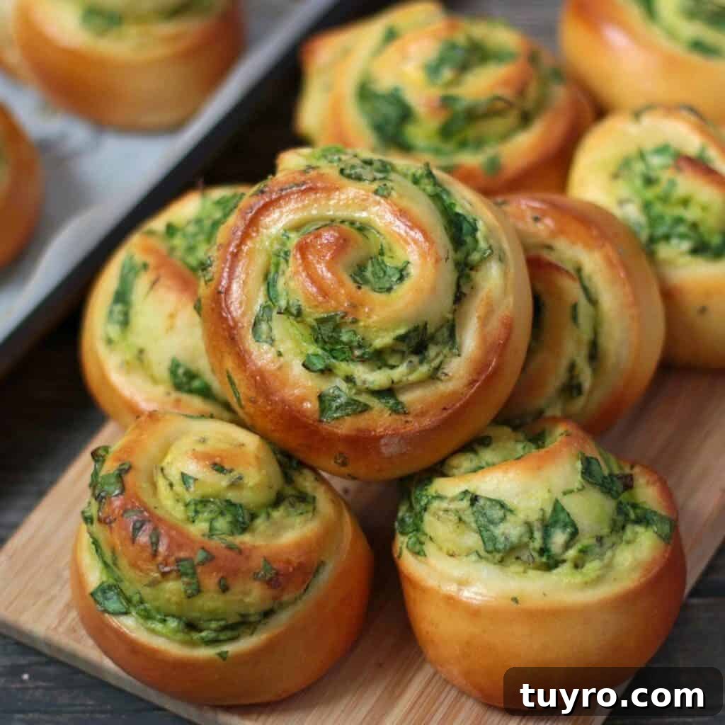 St Patricks Day Appetizers for a Festive Party 14 spinach and ricotta rolls stacked on a cutting board.