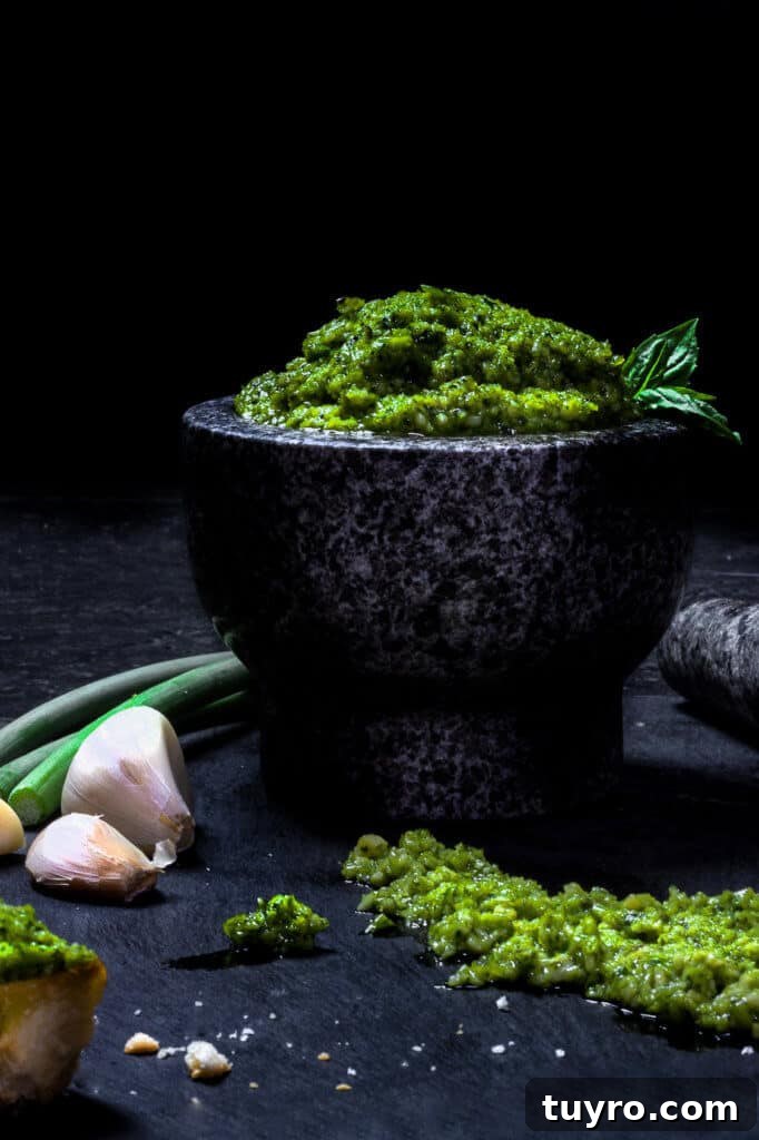 St Patricks Day Appetizers for a Festive Party 15 green garlic scape pesto in a mortar with garlic on the side.