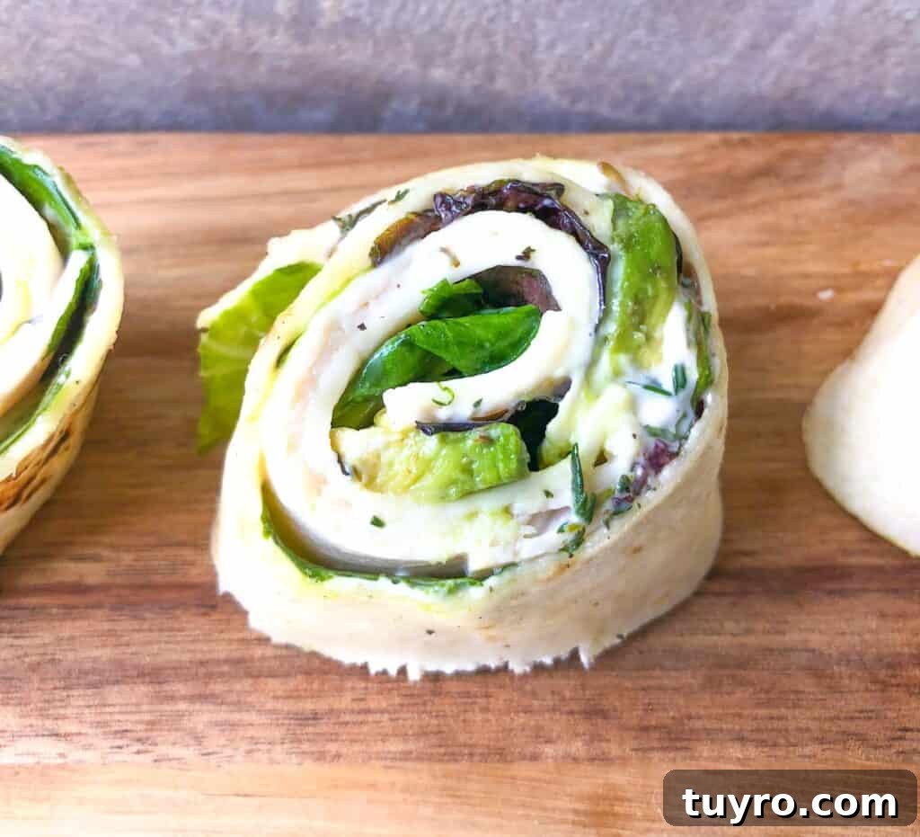St Patricks Day Appetizers for a Festive Party 4 Avocado thyme turkey tortilla rollups on a board.