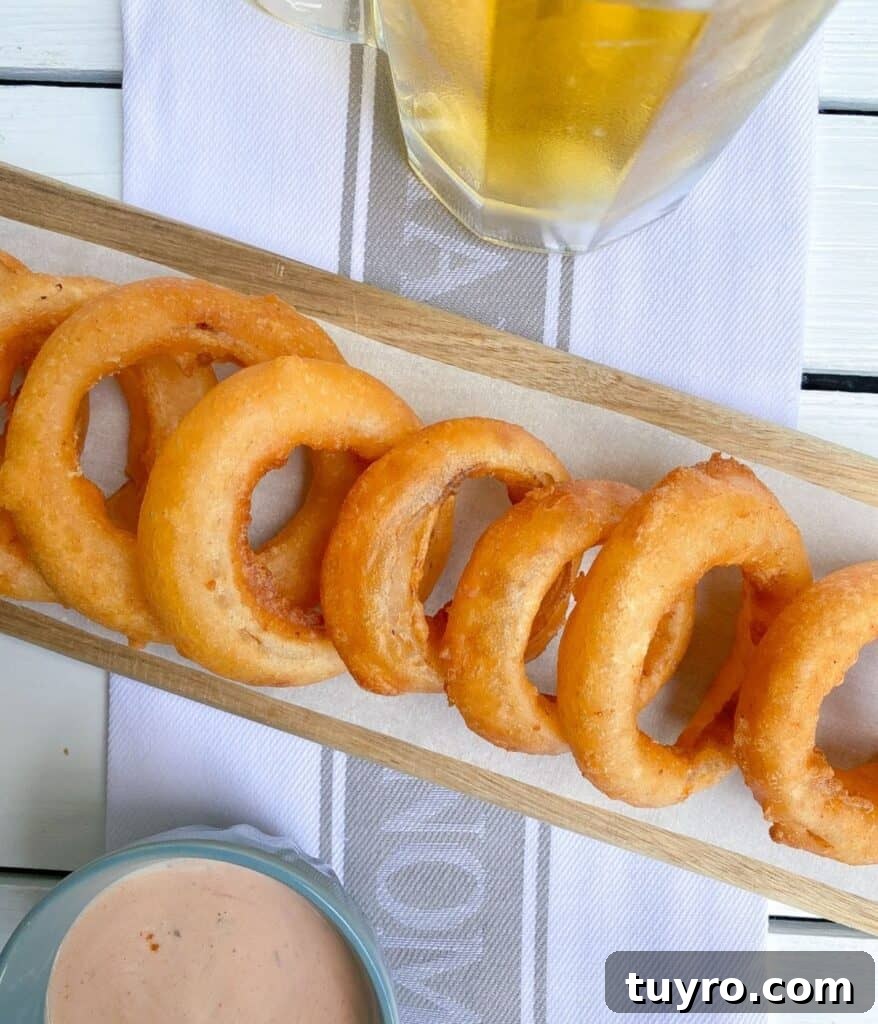 St Patricks Day Appetizers for a Festive Party 5 beer battered onion rings on cutting board.