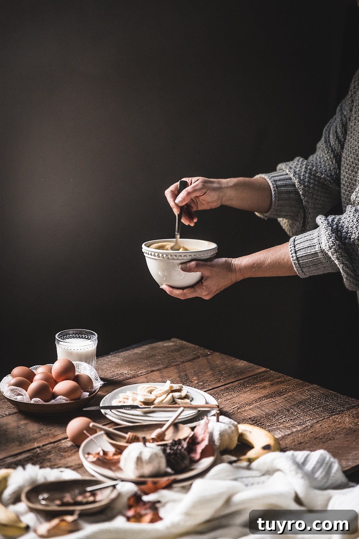 2-Ingredient Banana Pancakes: Egg & Banana Recipe 9 hands wearing soft grey sweater vigorously stir eggs and bananas for 2 ingredient pancakes