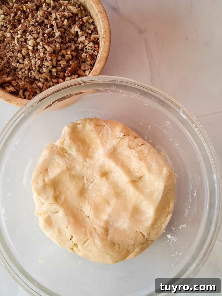 crust dough in one bowl, chopped pecans in another bowl.