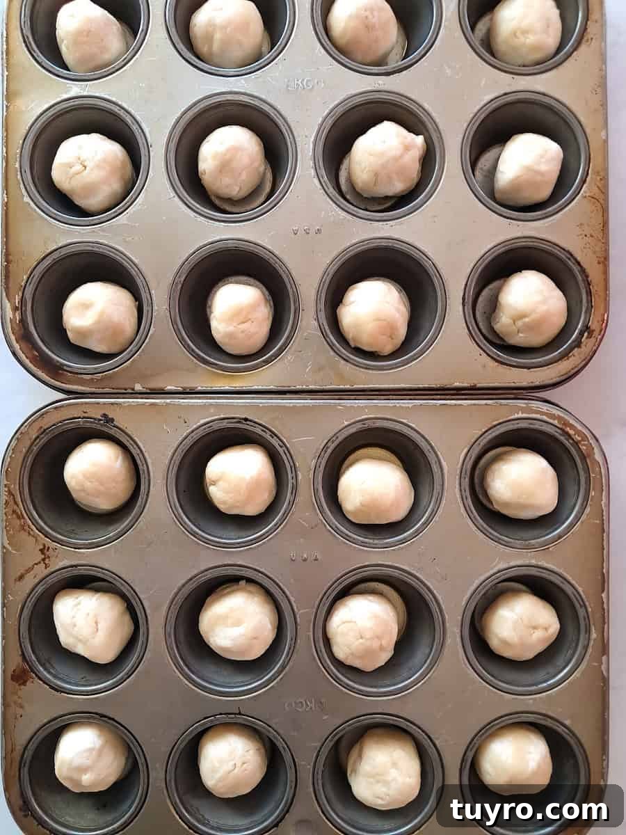 dough balls in muffin tins.