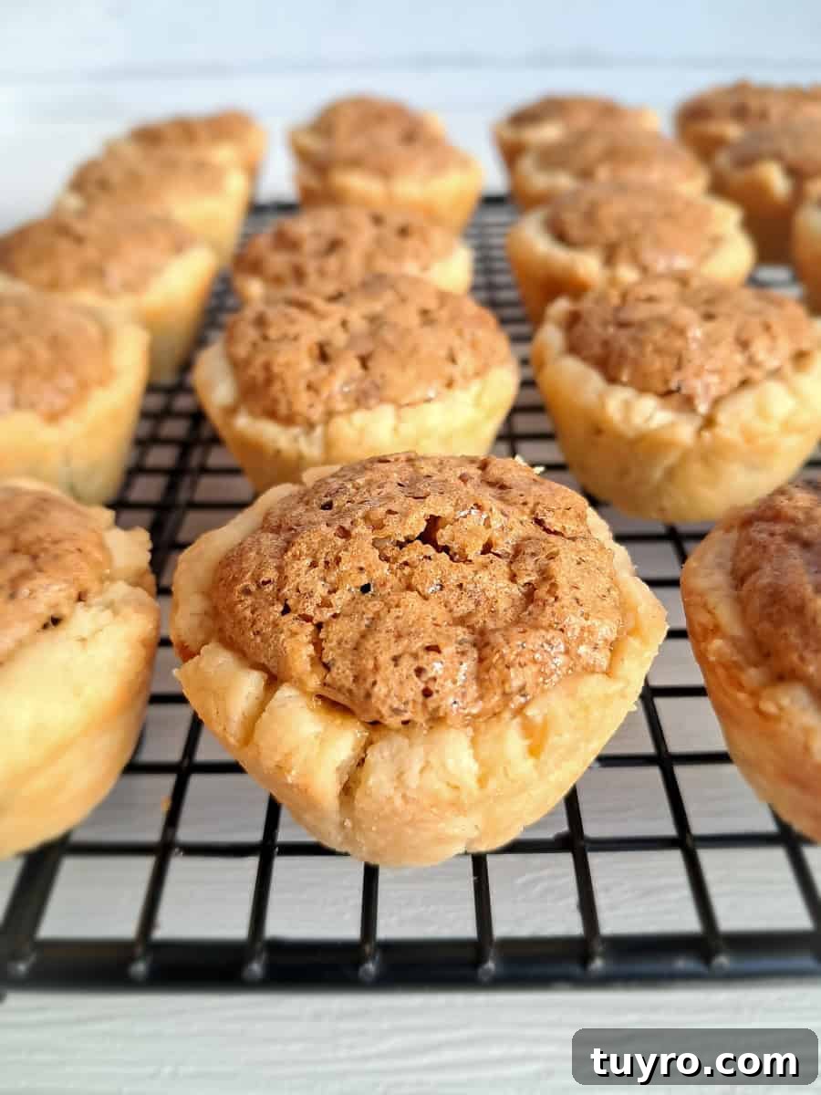mini pecan pies on a wire cooling rack.