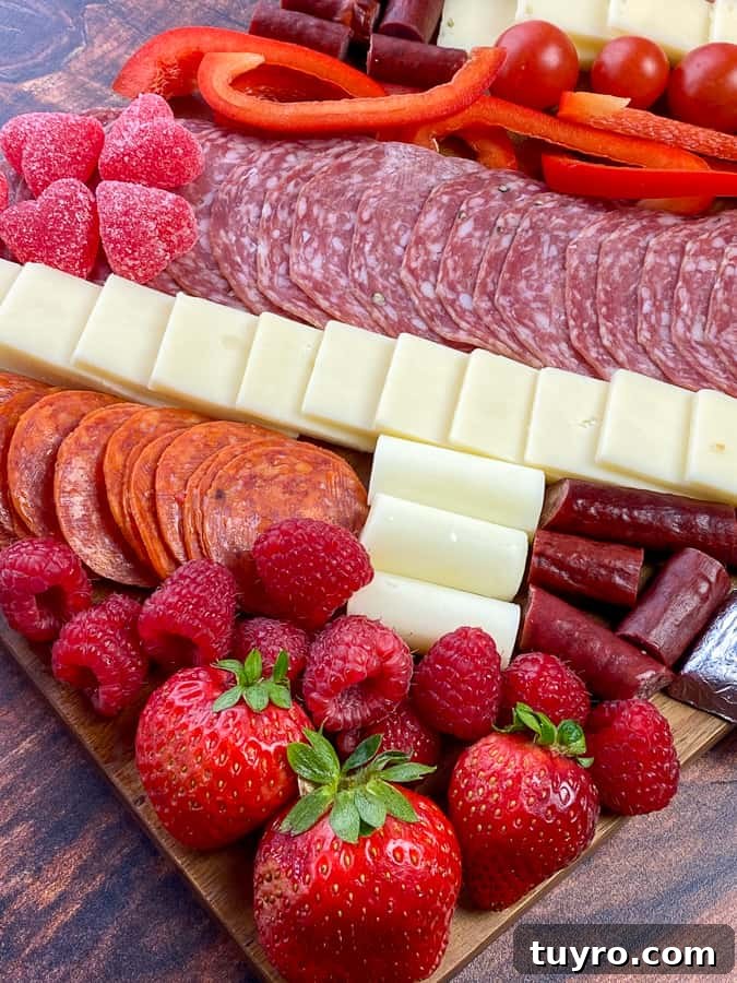 Simple Charcuterie Board Guide: Build a Beautiful Snack Platter 4 Common fruit, meat, cheese sticks and slices and candy on a cheap charcuterie board