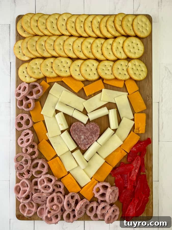 Simple Charcuterie Board Guide: Build a Beautiful Snack Platter 5 A charcuterie board made by kids for an easy lunch or fun party with meat, cheese and crackers